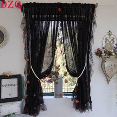 the window is decorated with black sheer curtains