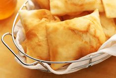 some food is in a metal basket on a table