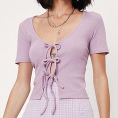 Brave Soul Brand Sold At Asos. Only Got Ties For You. This Top Comes In A Ribbed Jersey And Features A Scoop, V-Neckline, Relaxed Fit, Cropped Length, Open Front With 3 Adjustable Bow Tie Closures, Boxy Silhouette And Fitted Short Sleeves. Color Is A Pupleish Mauve. Made From 95% Cotton 5% Elastane Which Is Medium-Weight And Stretchy. Wear On Its Own Or With A Bralette Underneath. Nwt. Make An Offer Or Bundle! Approx Measurements (Laying Flat) - Pit To Pit: 17" - Shoulder To Hem: 18.5" Purple V-neck Top For Day Out, Fitted Mauve Summer Top, Fitted Mauve Top For Summer, Trendy Fitted Mauve Tops, Mauve Cotton Tops For Spring, Trendy Lavender Tops For Day Out, Trendy Lavender Top For Day Out, Fitted Mauve V-neck Top, Cotton Lavender Top For Day Out