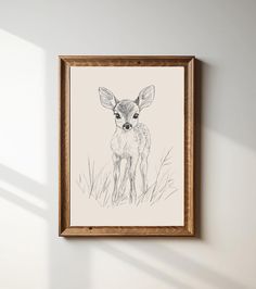 a drawing of a deer is hanging on the wall in front of a white wall