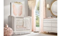 a baby's room with pink and white decor