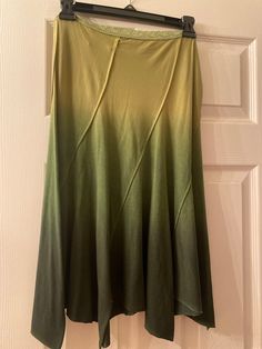 a green and yellow skirt hanging on a door