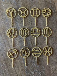 twelve zodiac symbols are arranged on top of each other to make them look like lollipops