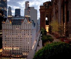 the city skyline is lit up at night, with tall buildings in the foreground