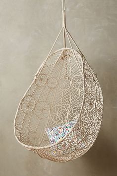 a white hanging chair with an intricate design