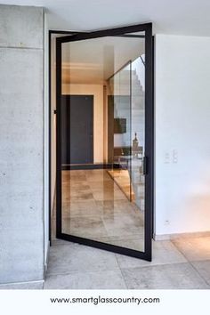 an open glass door in the middle of a room with white walls and tile flooring