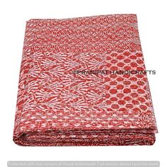 a red and white blanket with an animal print pattern on the bottom, in front of a