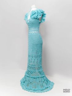 a crocheted dress is displayed on a mannequin's headdress