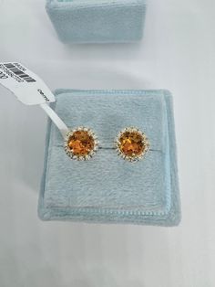 Beautiful Round Halo Citrine and Diamond Stud Earrings Yellow Gold.  Simple and classy earrings.  Excellent craftsmanship, the halo of diamonds frame the citrine beautifully.  The diamonds are very sparkling.  The halo measures about 7.7mm.   The push backings have 2 security notches for a secure fit.  The backs are big and strong.   Genuine citrine 5mm round cuts  Total weight: 0.87 carats Genuine round brilliant cut diamonds  Total weight: 0.23 Clarity: SI Color: G Solid 18K Yellow Gold 2.13 grams  Comes with gift box AT1700 * We have been in the wholesale Jewelry business for over 30 years serving the community at the same location.  All diamonds we use are natural stones and fine quality gold.  Absolutely NO clarity enhanced or treated diamonds. Our jewelry pieces are handcrafted with Luxury Citrine Earrings, Elegant Topaz Halo Jewelry, Formal Halo Cluster Earrings Fine Jewelry, Elegant Halo Topaz Jewelry, Formal Halo Cluster Earrings, Yellow Gold Topaz Earrings, Round Shape, Formal Round Citrine Earrings, Elegant Topaz Jewelry With Halo Design, Formal Yellow Gold Cluster Earrings With Halo Setting