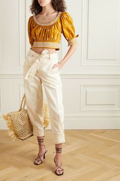 Ulla Johnson translates her serious case of wanderlust into beautiful garments that are designed to wear on holiday. Cut from cotton and linen-blend twill in an ivory hue, these tapered pants sit on the natural waist and are detailed with buttons at the cuffs. Match your top to the contrast stitching.                                           Levi belted cotton and linen-blend twill tapered pants .Ulla Johnson Levi Pant in Neutral 66% cotton 34% linen. Made in India. Dry clean only. Zip fly with Summer Workwear Pants With Belt Detail, Elegant Belted Cotton Pants, Cropped Cotton Bottoms With Belt Loops, Summer Workwear Bottoms With Belt Detail, Spring High-waisted Pants With Belt Detail, Chic Spring Pants With Belt Detail, Chic Cotton Bottoms With Belt Detail, Cropped Pants With Belt Loops For Spring, Spring Trousers With Belt Detail