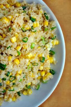 a white plate topped with rice and corn