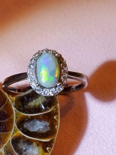 1ct Australian lightning ridge opal, surounded by CZ size 7, 925 silver 4 prong ring. Simple yet beautiful, going fast as I can make em. Silver Opal Ring With Halo, Opal Ring With Halo Setting For Anniversary, Engagement Ring Opal, Opal Wedding Band, Australian Opal Ring, Prong Ring, Opal Engagement Ring, Opal Wedding, Lightning Ridge Opal