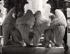 an angel statue sitting on top of a fountain