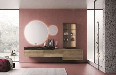 a modern bathroom with pink walls and flooring, including a large mirror on the wall