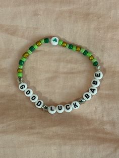 a beaded bracelet with the words good luck on it