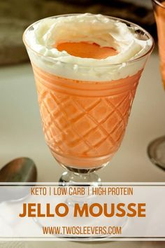 an orange jello mousse in a glass with whipped cream on top and the text keto i low carb high protein jello mousse