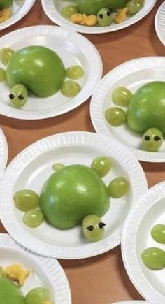 paper plates with green apples shaped like animals on them