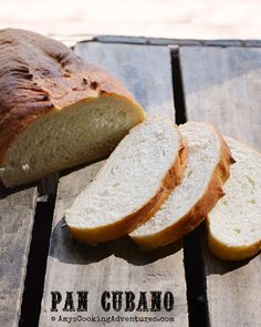 two loaves of bread sitting on top of a wooden table