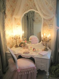 a dressing table with a mirror and candles