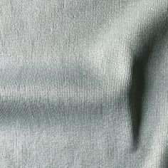 a close up view of the texture of a gray fabric