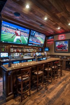 a sports themed bar with multiple televisions on the wall