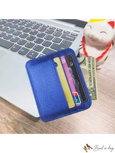 a wallet sitting on top of a laptop computer