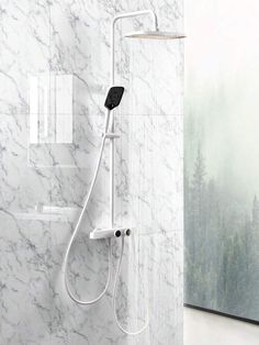 a shower head with thermostaer attached to it in a white marble bathroom