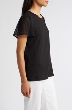 A smocked bodice meets a mesh clip-dot yoke and sleeves on a woven top cut from lightweight fabric with a hint of stretch. 24 1/2" length Jewel neck Short sleeves 95% polyester, 5% spandex with 100% polyester trim Machine wash, dry flat Imported Spring Workwear Tops With Mesh Sleeves, Black Summer Blouse With Elastic Sleeves, Black Flutter Sleeve Fitted Blouse, Black Swiss Dot Blouse For Spring, Chic Black Swiss Dot Top, Black Short Sleeve Blouse With Smocked Back, Hairstyling Products, Rollerball Perfume, Smocked Top