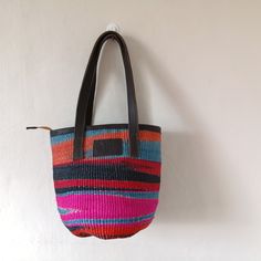 This elegant handmade sisal bag with leather straps and African print cotton inner lining with a side pocket to store small sized items has been made to serve you during all seasons. It can be used as an everyday handbag, a summer bag or even as a diaper bag. Artisan Bucket Straw Bag For Everyday Use, Artisan Straw Bucket Bag For Everyday Use, Artisan Woven Bags For Everyday Use, Handmade Natural Canvas Bag For Everyday Use, Everyday Handwoven Bucket Bag, Handwoven Tote Bucket Bag For Travel, Handwoven Bucket Tote Bag For Daily Use, Handwoven Tote Bucket Bag For Everyday, Artisan Tote Beach Bag For Travel