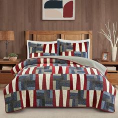 a bed with red, white and blue bedspread