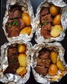 four pieces of foil with meat and potatoes in them