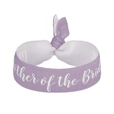 a purple and white headband with the word bride on it