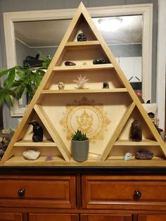 a wooden shelf filled with lots of different types of items on top of each other