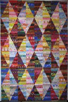 a colorful quilt hanging on the wall