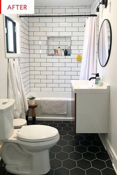 a white toilet sitting in a bathroom next to a sink and bathtub under a window