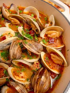 clams and chorizo in a white bowl