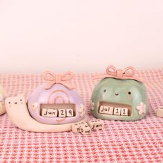 three ceramic figurines sitting on top of a table