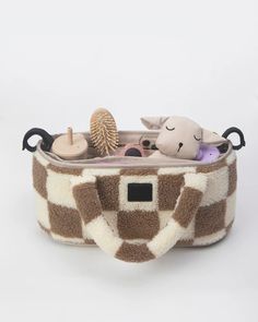 a giraffe print case with toys in it on a white background, including an elephant