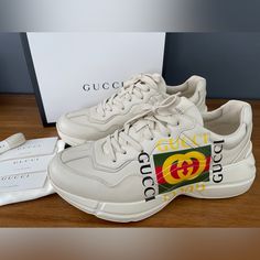 Gucci Men's Apollo Size Gucci 9+ (Us 10) Insole Length: Approximately 28 Cm New In Box, Guaranteed Authentic Made In Italy 100% Authentic White Rubber Sole Gucci Name In Shoe, Stars On Sole With Gucci Name Logo Gucci Printed Feature In Yellow And Green And Red On Side Of Shoe Lace-Up Closure Low Heel: 1.6" Height Cream Leather Sneakers With Logo, Beige Leather Sneakers With Logo, Designer Beige Leather Sneakers, Classic Gucci Sneakers With Embossed Logo, Gucci White Calf Leather Sneakers, White Gucci Sneakers In Calf Leather, White Gucci Calf Leather Sneakers, Luxury Gucci Beige Sneakers, Luxury Beige Gucci Sneakers