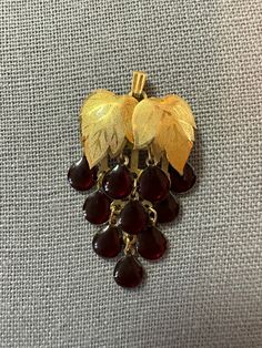 Vintage gold tone, grape cluster pin brooch pendant with garnet colored grapes. Grapes dangle. Clasp is in good working order. Grape Accessories, Grape Jewelry, Pearl Grapes Earrings, Grape Jewelry Gold, Dressage Stock Tie, Stock Tie, Vintage Gold-tone Jewelry Brooch, Garnet And Gold, Pin Pendant