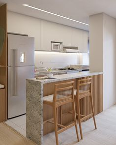 a kitchen with two stools next to a counter top and an island in the middle