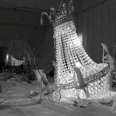 an ice sculpture is shown in the middle of a room with chairs and other items