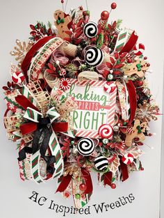 a christmas wreath with candy canes, candies and other holiday decorations on it