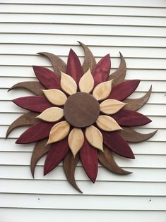 a wooden sunflower on the side of a building