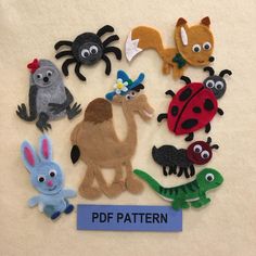 a group of felt animals and bugs on top of a white sheet with the words pdf pattern