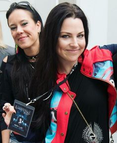 two women standing next to each other smiling