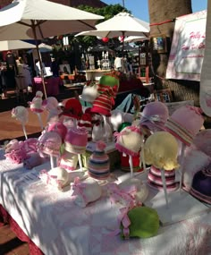 many hats are on display at an outdoor market