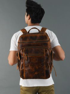 Trustpilot Our handmade leather Alpha backpack is the perfect choice for your travel need. Carry your travel essentials in a trendy and convenient way with our super spacious backpack bag. The bag comes with multiple pockets and a main zipper compartment which gives easy access to the inside main compartment. The backpack has two adjustable straps on the back for adjusting as per your comfort. The premium backpack is crafted from high-grade buffalo leather giving it a vintage and eye-catchy look Brown Leather Backpack With Zipper Closure, Brown Leather Travel Backpack With Zipper Pocket, Brown Leather Backpack With Zipper Pocket For Travel, Travel Backpack With Luggage Sleeve In Brown, Large Capacity Leather Satchel Backpack For Trips, Brown Leather Backpack With Zipper Pocket, Leather Backpack With Luggage Sleeve For Trips, Rectangular Leather Backpack With Zipper Pocket For Trips, Brown Backpack With Luggage Sleeve