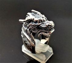 Chinese Dragon RingPure 925 Sterling Silver Unisex Ring with Black Onyx EyesThis beautiful Exclusive Design Dragon Ring has been Fabulously casted with .925 Sterling SilverThe weight of the Ring is 27-28 grams*please inquire if you don't see your size listed*Please allow 2-3 weeks shipping as we are in Bangkok Thailand at this timeWe are a Los Angeles based company operating out of Thailand so that we may bring you the highest quality items at the most competitive prices. Just search and compare Silver Dragon Design Jewelry For Formal Occasions, Formal Silver Jewelry With Dragon Design, Silver Jewelry With Dragon Design For Formal Occasions, Black Jewelry With Dragon Design Collectible, Collectible Black Jewelry With Dragon Design, Traditional Black Jewelry With Polished Finish, Black Spiritual Jewelry With Dragon Design, Spiritual Black Jewelry With Dragon Design, Black Carved Sterling Silver Jewelry