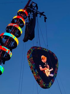 an image of a man playing guitar in the air at a music festival or show